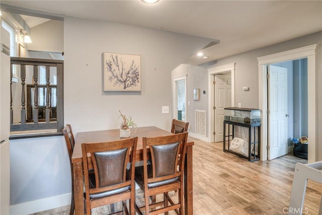 dining space with light hardwood / wood-style flooring