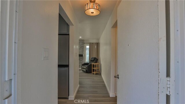 hallway with hardwood / wood-style flooring