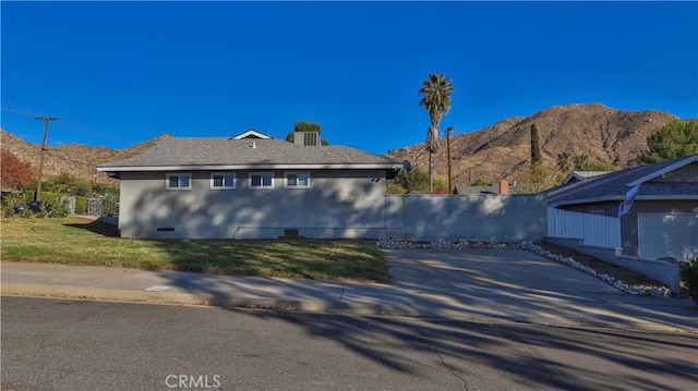 view of side of property with a mountain view