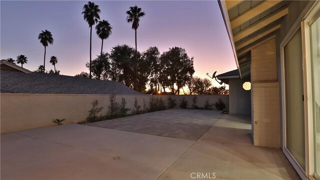 view of patio terrace at dusk