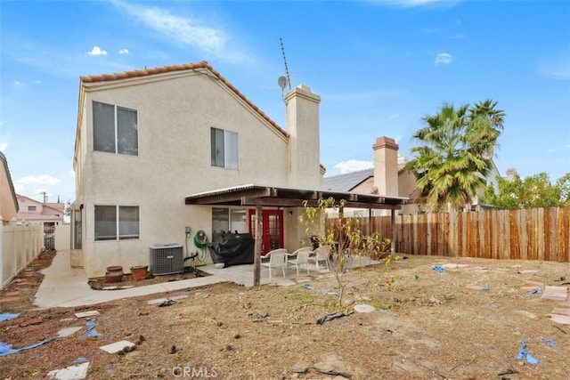 rear view of property featuring a patio area and central AC unit