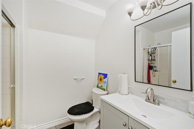 bathroom featuring vanity, toilet, and walk in shower