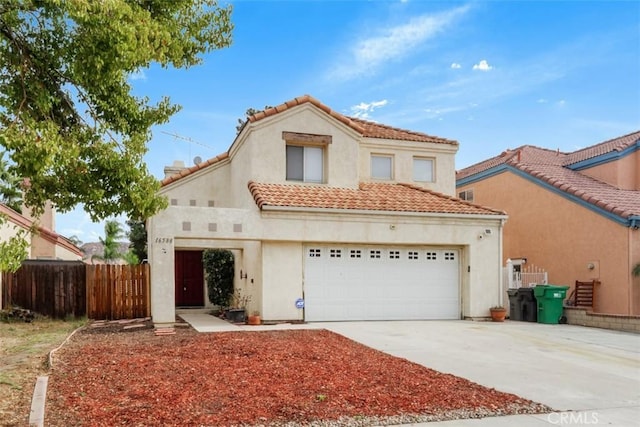 mediterranean / spanish house featuring a garage