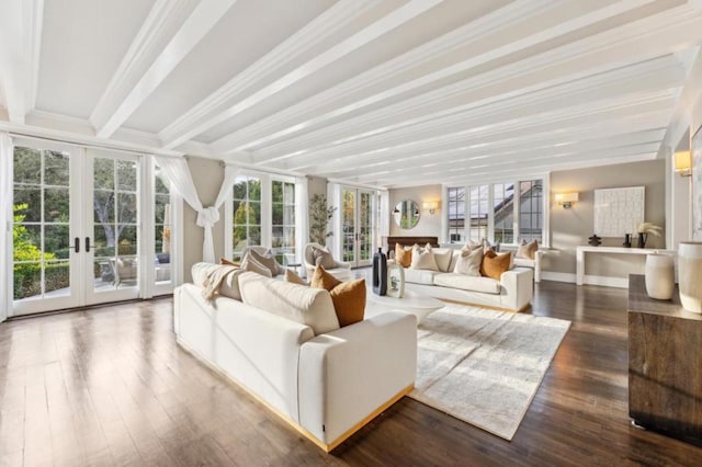 sunroom featuring beamed ceiling and french doors