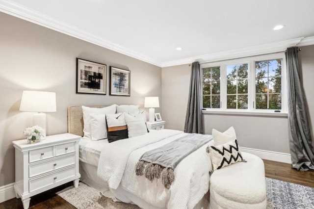 bedroom with ornamental molding and dark hardwood / wood-style flooring