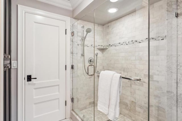 bathroom with crown molding and an enclosed shower