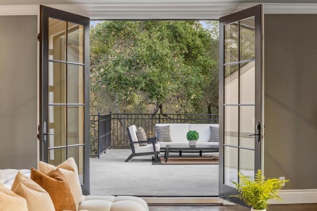 doorway featuring crown molding, a wealth of natural light, and floor to ceiling windows