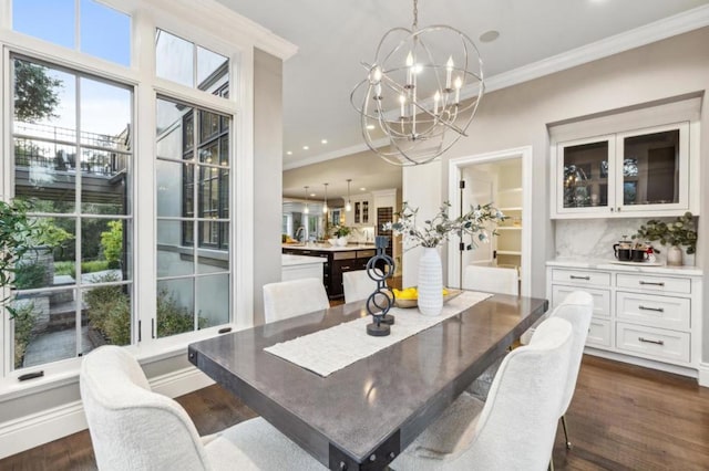 dining space featuring a notable chandelier, crown molding, and dark wood-type flooring