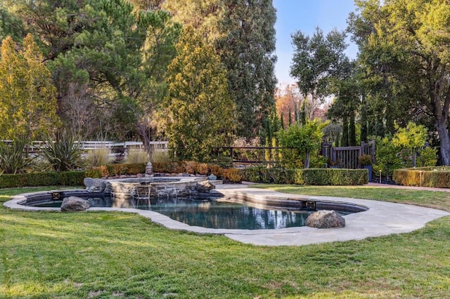 view of swimming pool with a yard