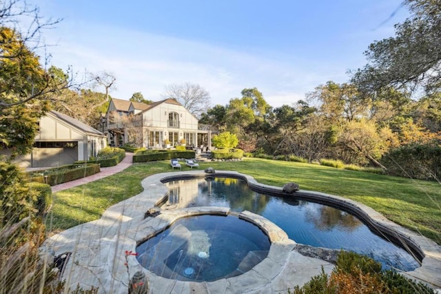 view of swimming pool with a lawn and an in ground hot tub