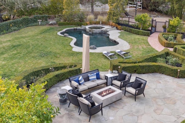 view of patio with a pool with hot tub and a fire pit