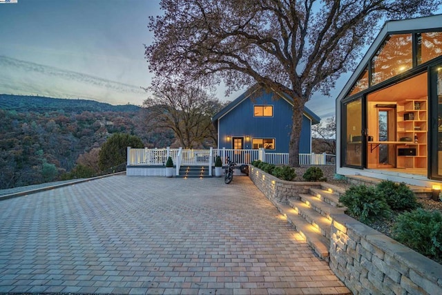 patio terrace at dusk featuring a mountain view