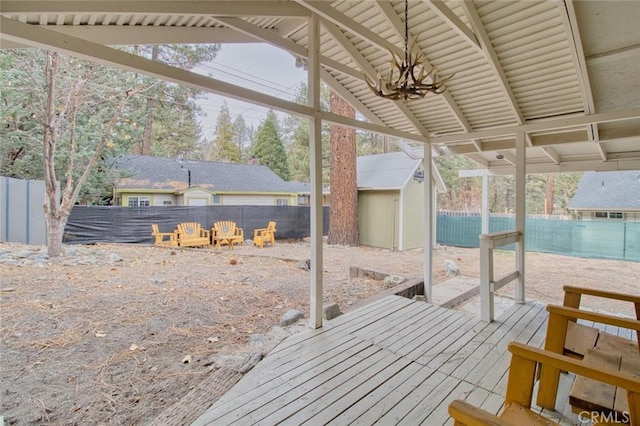 exterior space featuring a fire pit and a storage shed