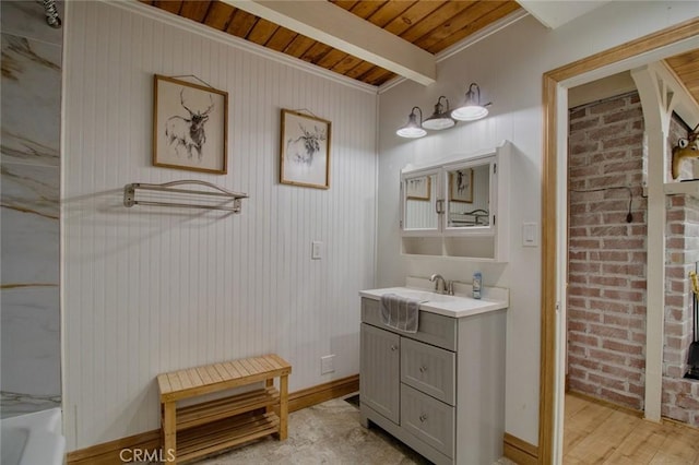 bathroom with wooden ceiling, vanity, beamed ceiling, brick wall, and hardwood / wood-style floors