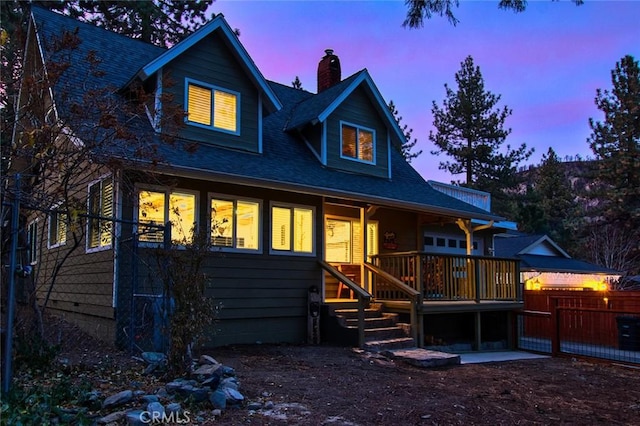 view of back house at dusk