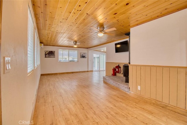 unfurnished living room with ceiling fan, light hardwood / wood-style floors, and wooden ceiling