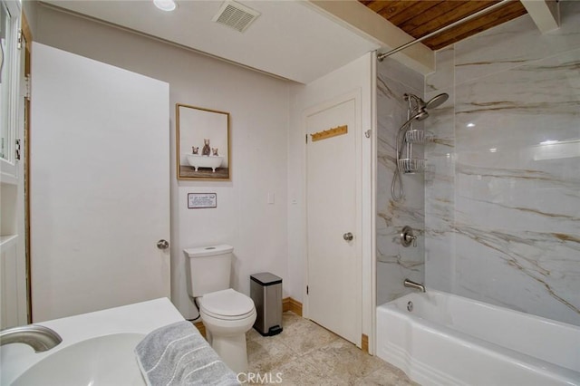 full bathroom with tiled shower / bath combo, sink, and toilet