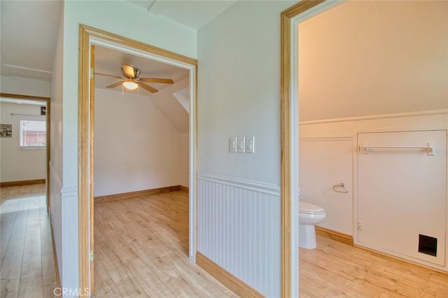 bathroom featuring wood-type flooring, toilet, ceiling fan, and vaulted ceiling