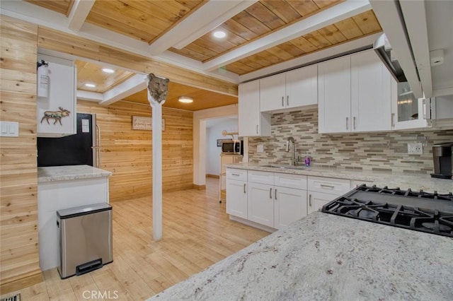 kitchen featuring sink, wood ceiling, white cabinetry, light stone countertops, and beamed ceiling