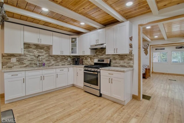 kitchen featuring white cabinetry, stainless steel range with gas cooktop, light stone counters, and light hardwood / wood-style floors