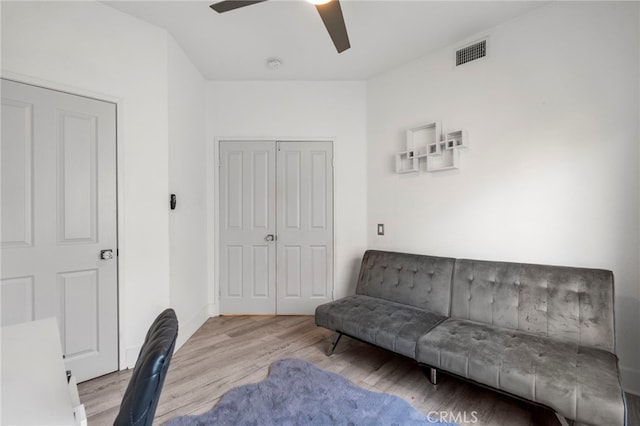 sitting room with ceiling fan and light hardwood / wood-style floors