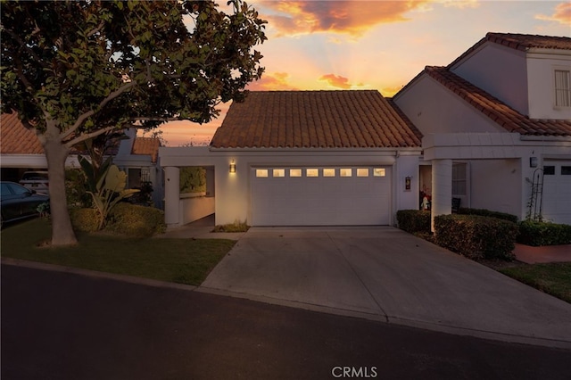 mediterranean / spanish-style house with a garage