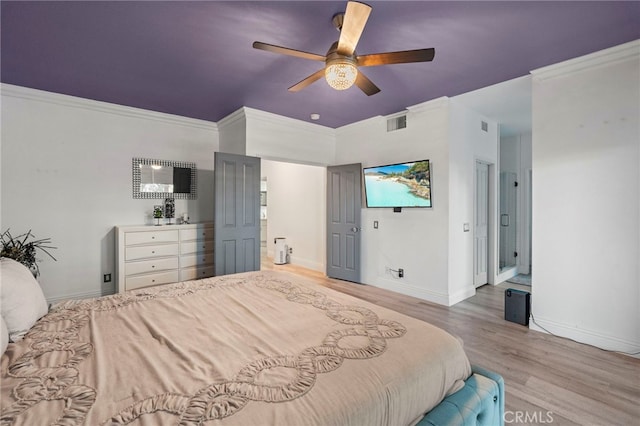 bedroom with ceiling fan, hardwood / wood-style floors, and ornamental molding