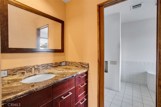 bathroom with tile patterned flooring and vanity