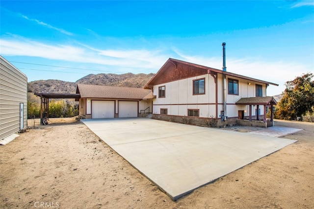 view of front facade featuring a mountain view and a garage