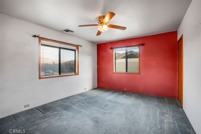 carpeted empty room featuring ceiling fan