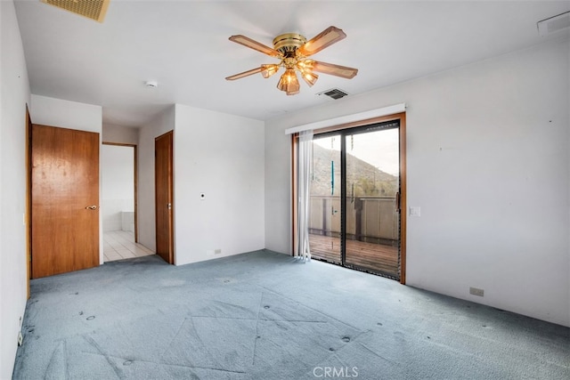 spare room with light carpet and ceiling fan