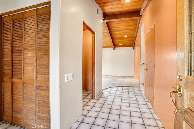 hall with beamed ceiling, light tile patterned floors, and wooden ceiling