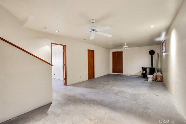 garage with a wood stove and ceiling fan