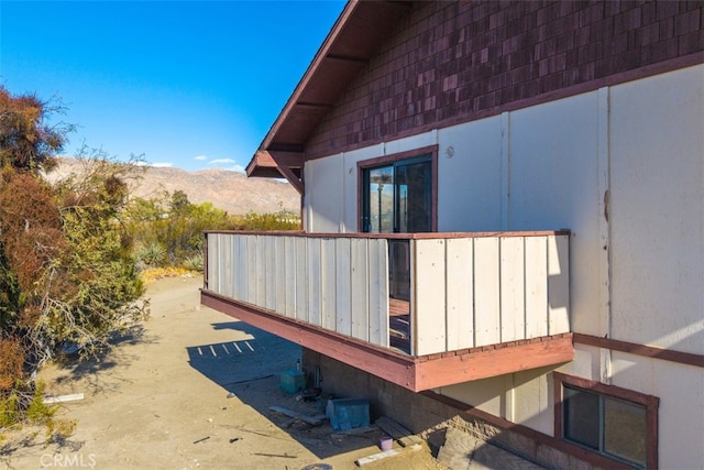 view of side of home with central AC unit and a mountain view