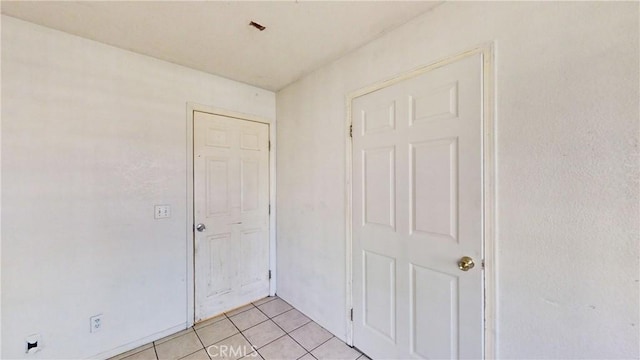 spare room with light tile patterned floors