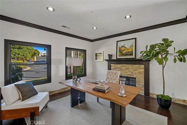 office with a stone fireplace, hardwood / wood-style floors, and ornamental molding