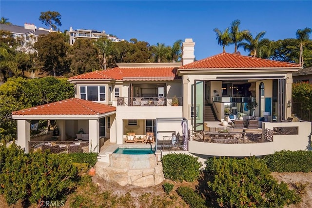 back of property with a patio area and a balcony