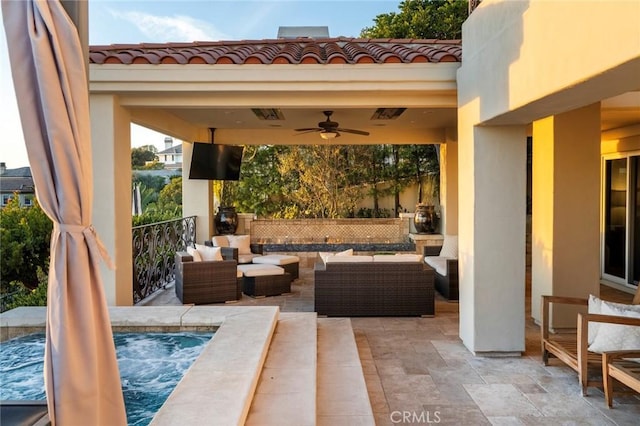 view of patio with an outdoor living space and ceiling fan