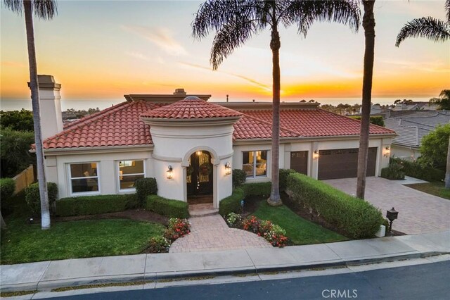 mediterranean / spanish-style house with a garage