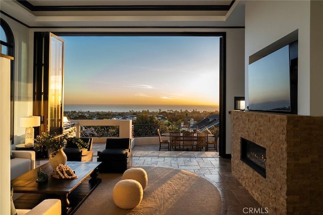 interior space with a water view and a tiled fireplace