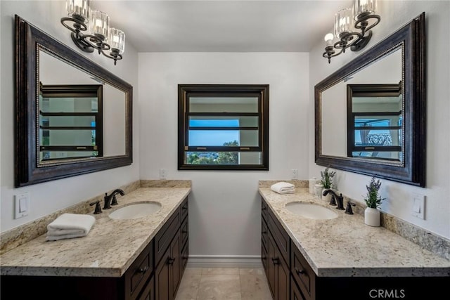 bathroom with vanity and an inviting chandelier