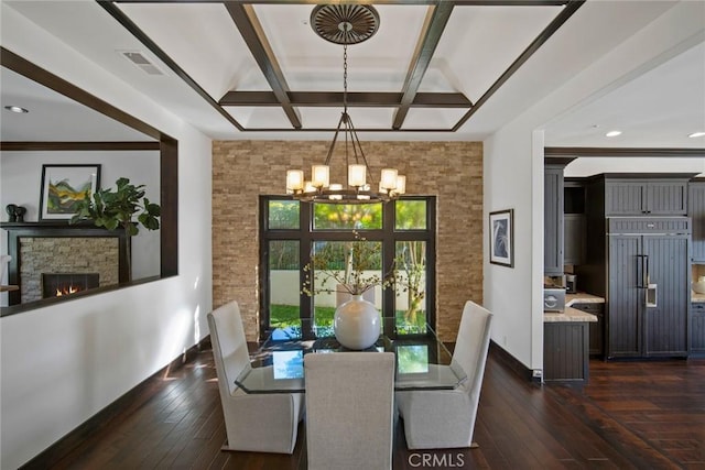 dining area featuring a fireplace, coffered ceiling, beamed ceiling, a chandelier, and dark hardwood / wood-style floors