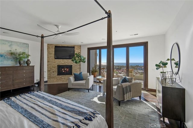 bedroom featuring ceiling fan and a fireplace