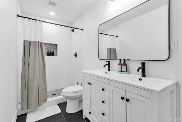 bathroom featuring tile patterned flooring, vanity, toilet, and curtained shower