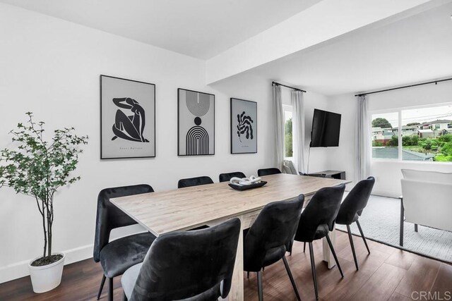 dining space with dark hardwood / wood-style flooring