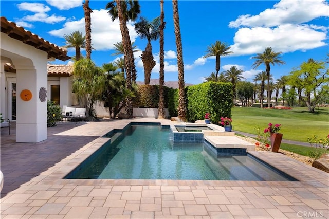 view of pool with a yard, an in ground hot tub, and a patio area