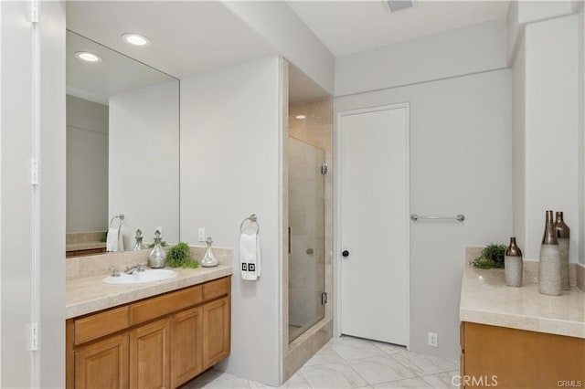 bathroom with walk in shower and vanity