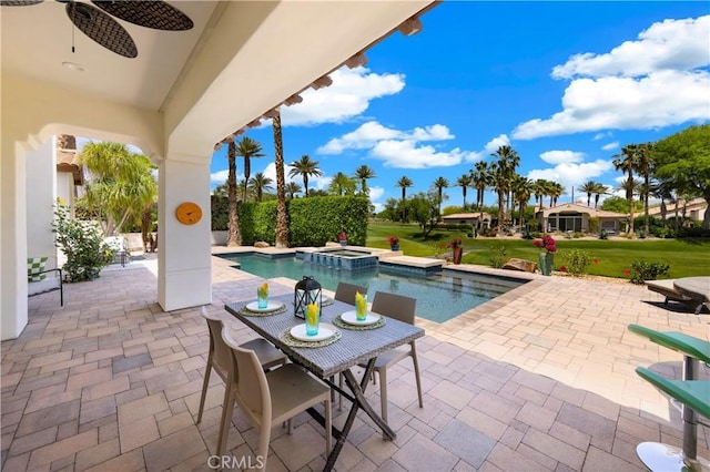 view of swimming pool with a lawn, a patio area, ceiling fan, and an in ground hot tub