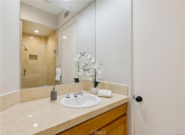 bathroom featuring vanity and walk in shower