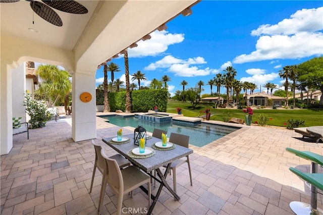 view of pool featuring a lawn, a patio area, ceiling fan, and an in ground hot tub